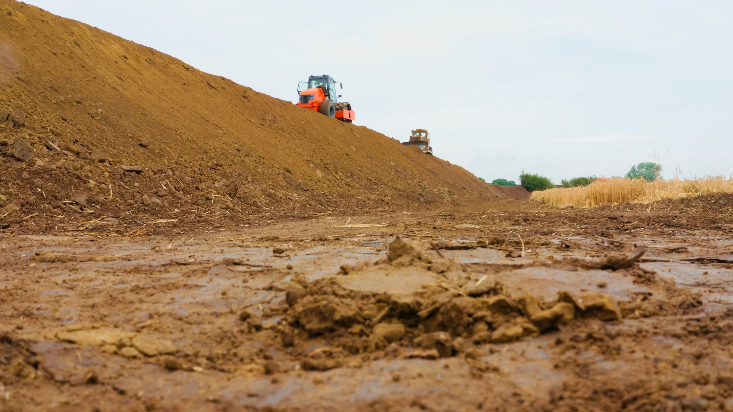 Earthmoving equipment performing mass grading on a construction site
